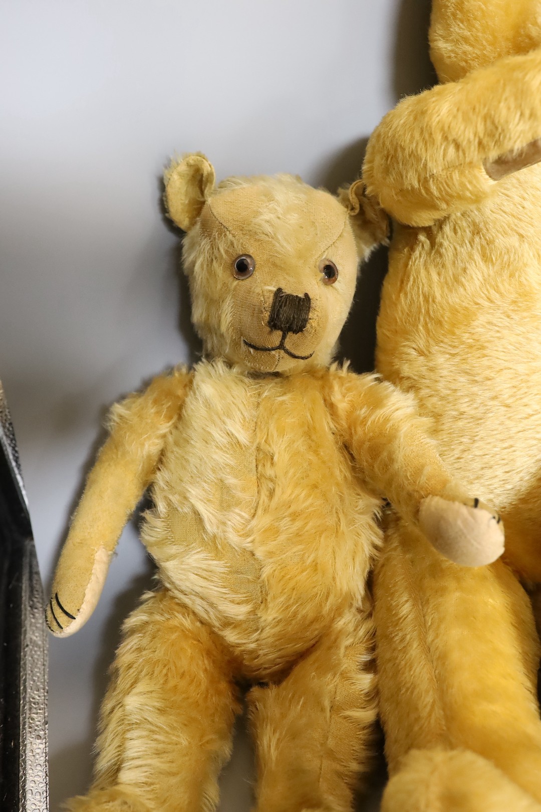 A large 1960's mohair bear, 75cm, a Chiltern 1930's bear, 50cm, and an English bear, dressed in bikers jacket and shirt, 54cm.